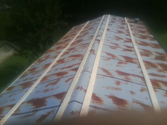 Rusted metal roof panels with new wood purlins before replacement — Storm Damage Roof Repair in Wright City by Roofing Brothers
